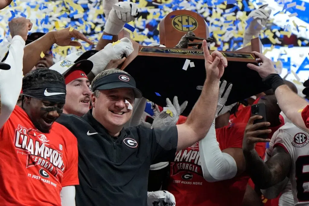 Georgia head coach Kirby Smart and team celebrate after a Southeastern Conference championship NCAA college football game against Alabama, Saturday, Dec. 6, 2025, in Atlanta. (AP Photo/Mike Stewart)