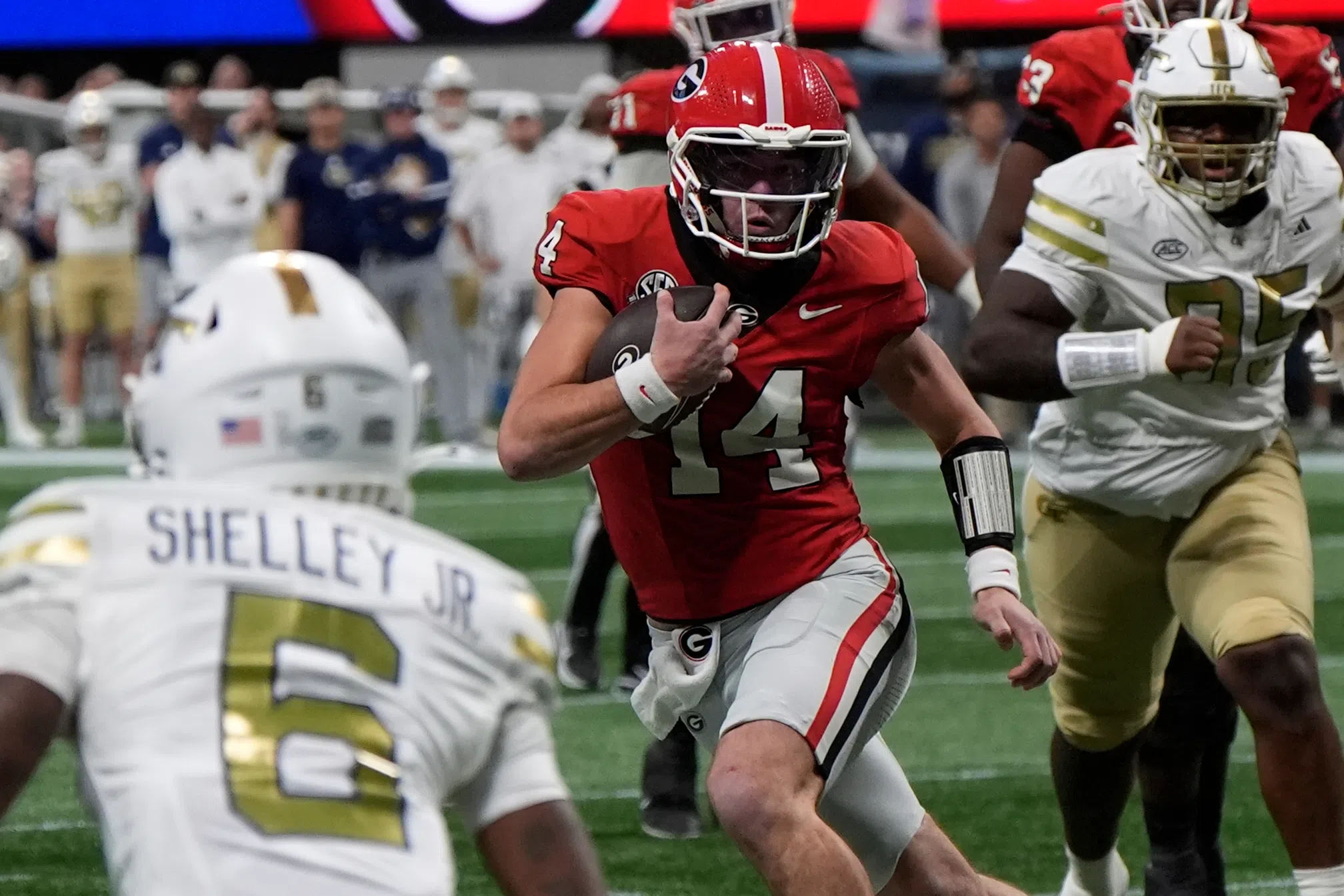 Georgia quarterback Gunner Stockton (14) runs against Georgia Tech defensive back Rodney Shelley (6)