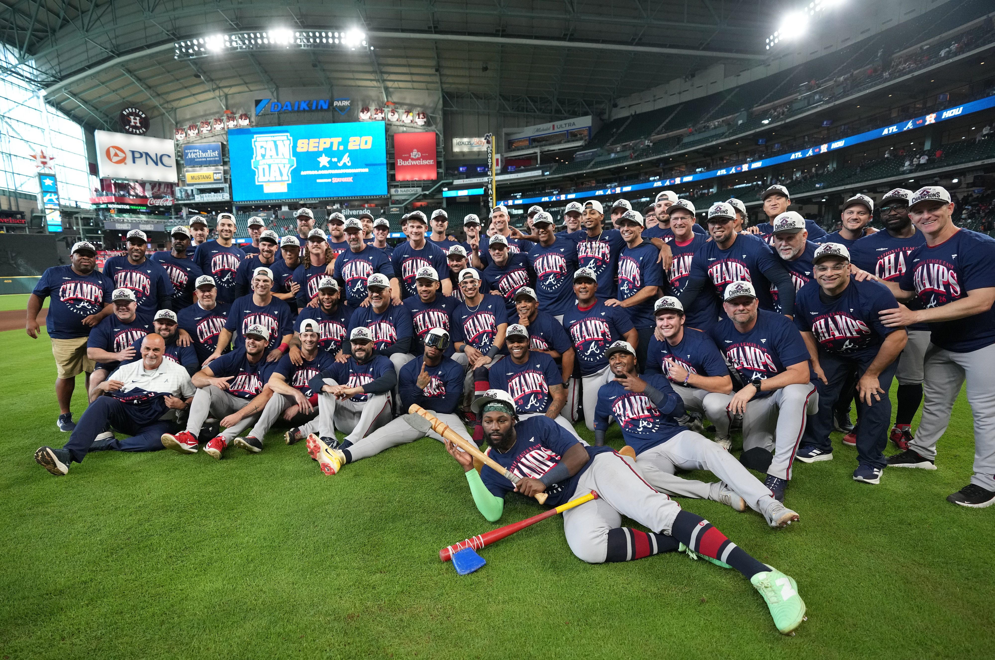 Atlanta Braves players and coaches take a group photo on the field after a baseball game 