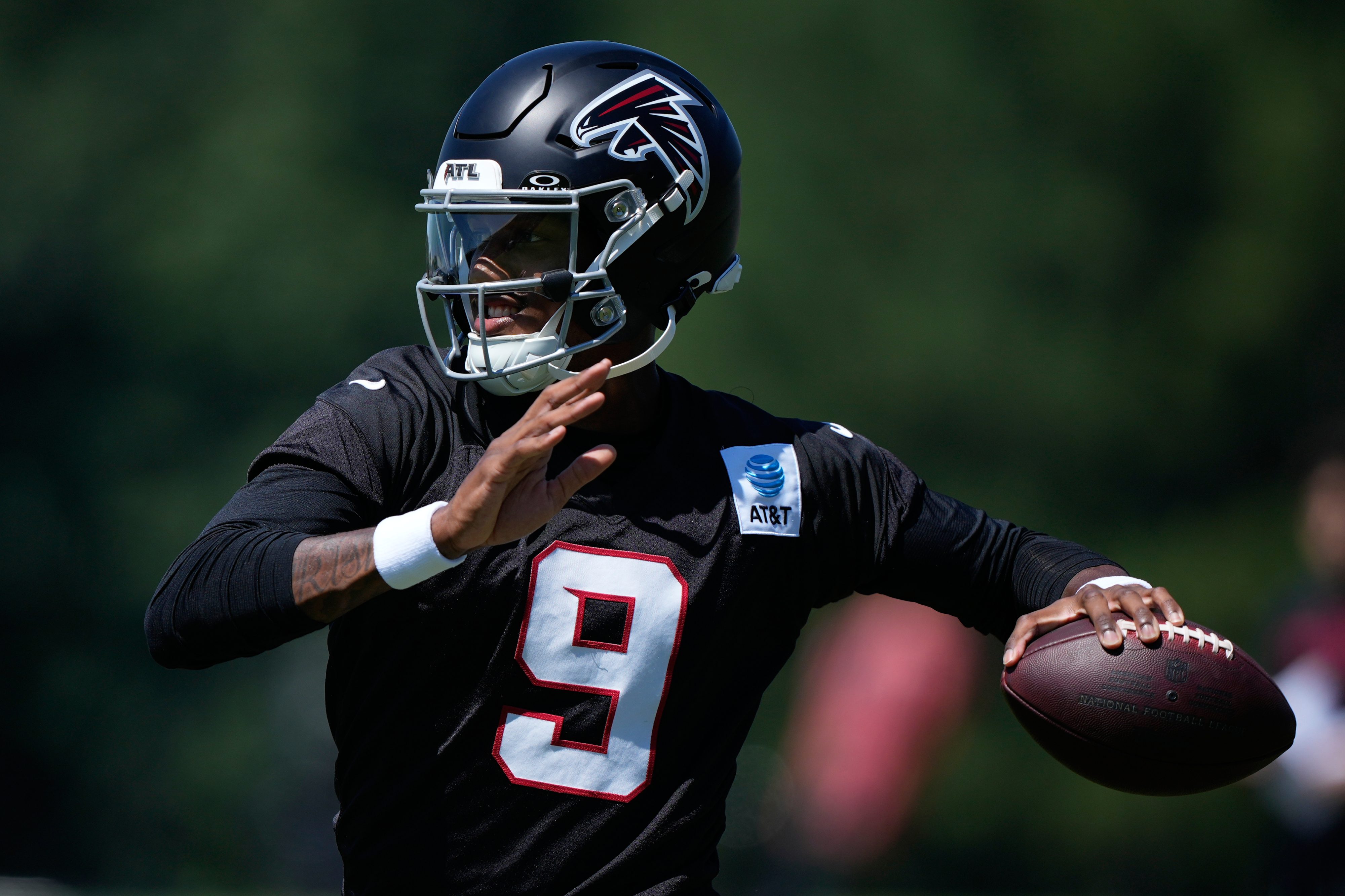 Atlanta Falcons quarterback Michael Penix Jr. (9) runs drills during an NFL football training camp