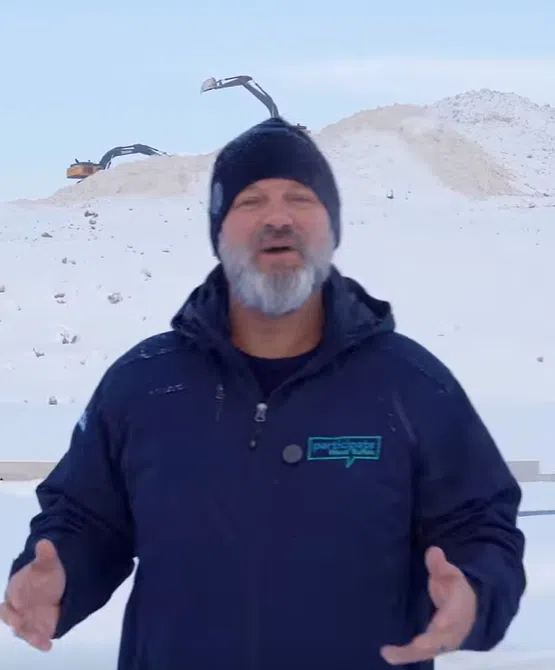 Mayor Bowman in front of largest Snow Mountain in RMWB History
