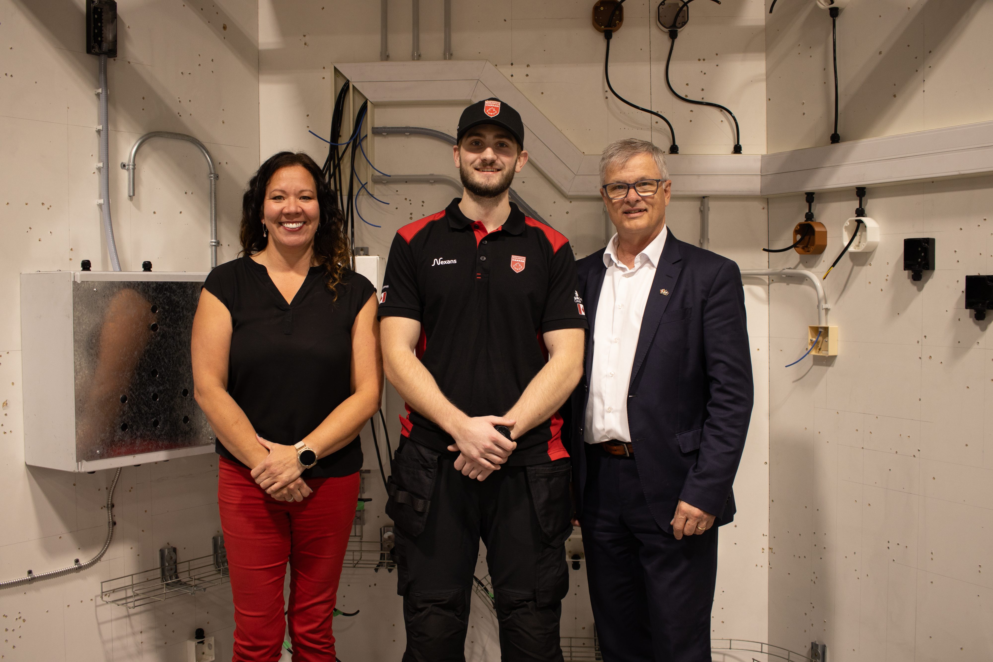 Pictured: Electrical Instructor Dawn Ohama, Keegan Sturge, and Minister of Advanced Education Myles McDougall.
