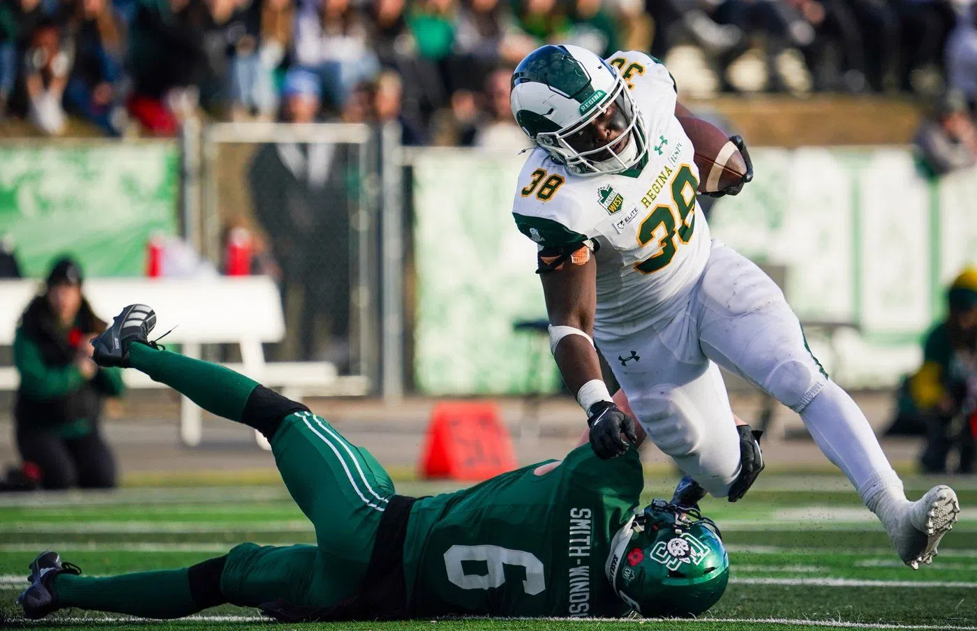University of Regina Rams running back Christian Katende (38) runs the football past University of Saskatchewan Huskies defensive back Tazmin Smith-Windsor (6) during the second half of U Sports Canada West Hardy Cup football championship action in Saskatoon, Sask., on Saturday, November 9, 2024. THE CANADIAN PRESS/Heywood Yu