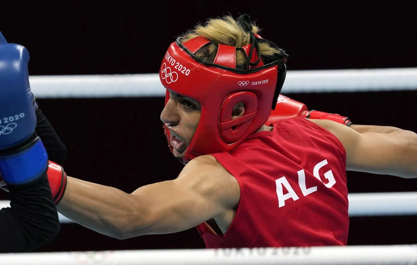 FILE - Imane Khelif, of Algeria, right, delivers a punch to Mariem Homrani Ep Zayani, of Turkey, during their women's light weight 60kg preliminary boxing match at the 2020 Summer Olympics, Friday, July 30, 2021, in Tokyo, Japan. (AP Photo/Themba Hadebe, File)
