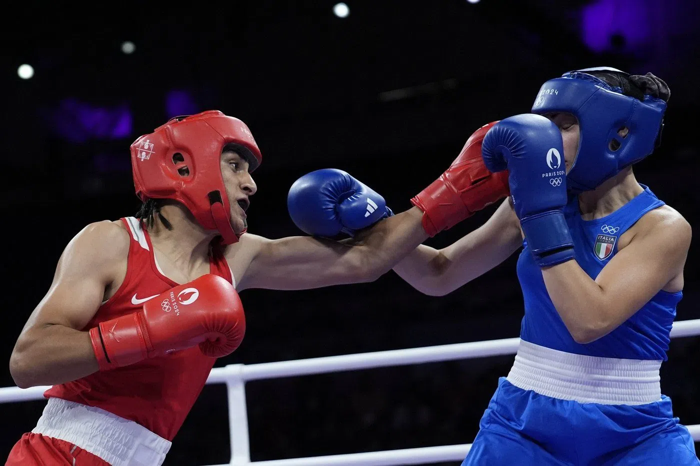 Algeria's Imane Khelif, left, fights Italy's Angela Carini in their women's 66kg preliminary boxing match at the 2024 Summer Olympics, Thursday, Aug. 1, 2024, in Paris, France. (AP Photo/John Locher)