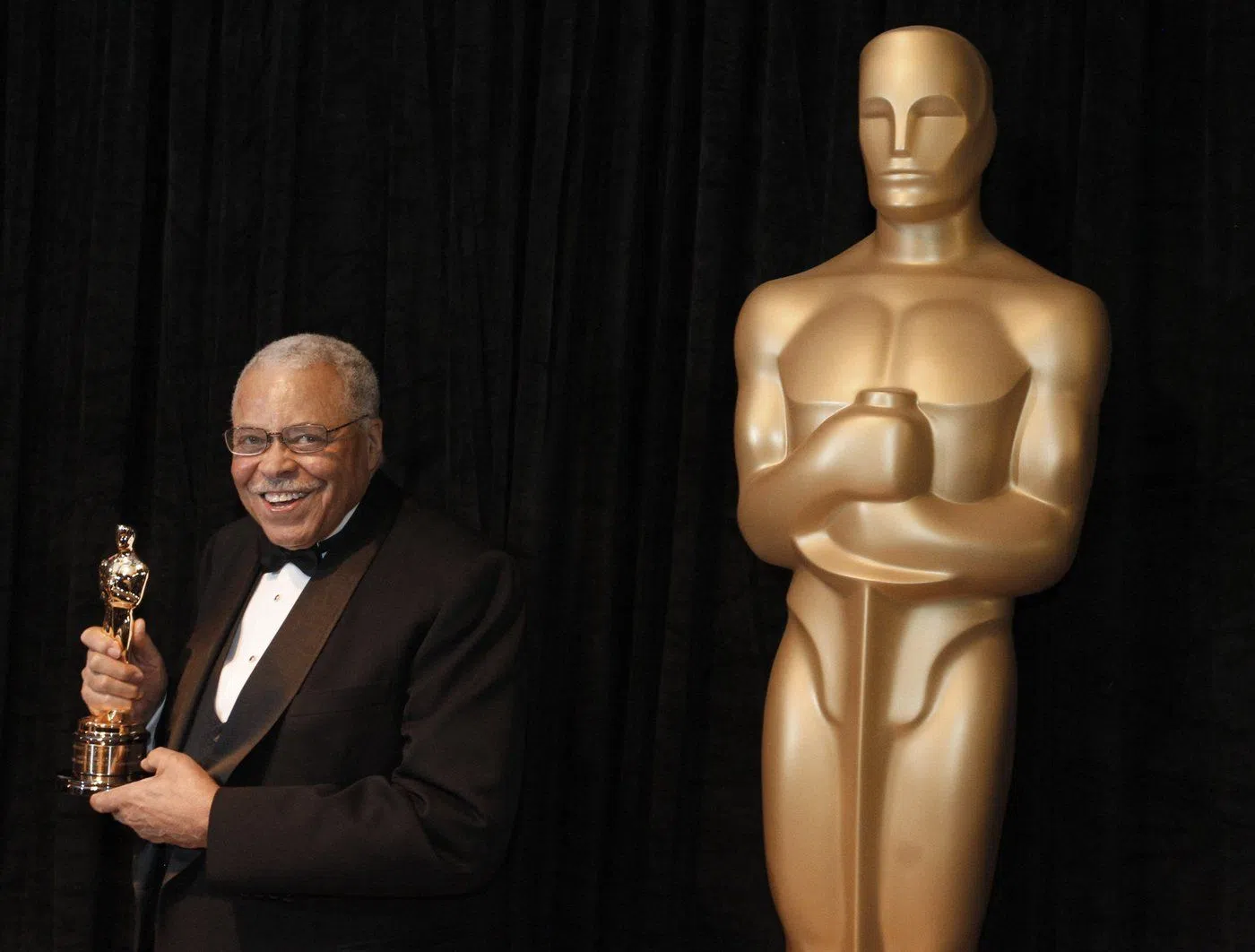 FILE - James Earl Jones poses with his honorary Oscar at the 84th Academy Awards on Sunday, Feb. 26, 2012, in the Hollywood section of Los Angeles. Jones, who overcame racial prejudice and a severe stutter to become a celebrated icon of stage and screen has died at age 93, Monday, Sept. 9, 2024. (AP Photo/Chris Carlson, File)