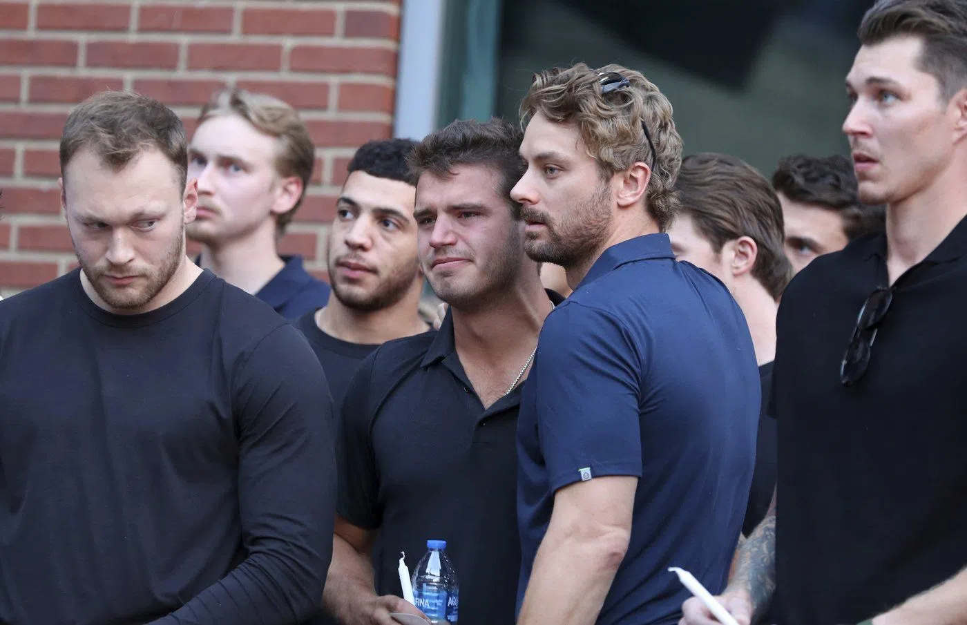 Columbus Blue Jackets player Cole Sillinger, center, reacts during the candlelight vigil to honor Columbus Blue Jackets hockey player Johnny Gaudreau, Thursday, Sept. 4, 2024, outside of Nationwide Arena in Columbus, Ohio. Gaudreau and his brother Matthew were killed by a motor vehicle last week while riding bicycles. (AP Photo/Joe Maiorana)