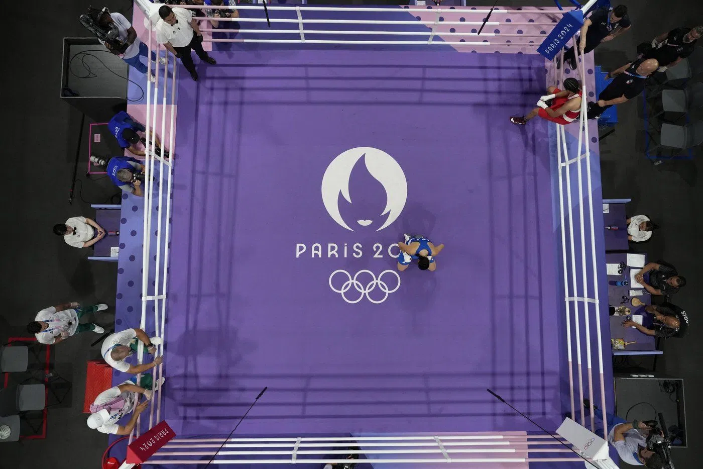 Italy's Angela Carini, center, reacts after she abandoned her fight against Algeria's Imane Khelif in their women's 66kg preliminary boxing match at the 2024 Summer Olympics, Thursday, Aug. 1, 2024, in Paris, France. (AP Photo/John Locher)