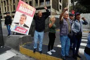 Supporters display a poster of Venezuelan President Nicolás Maduro