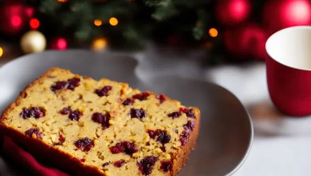 spiced fruitcake with holiday ornaments and cup in background - spiced fruitcake stock pictures, royalty-free photos & images