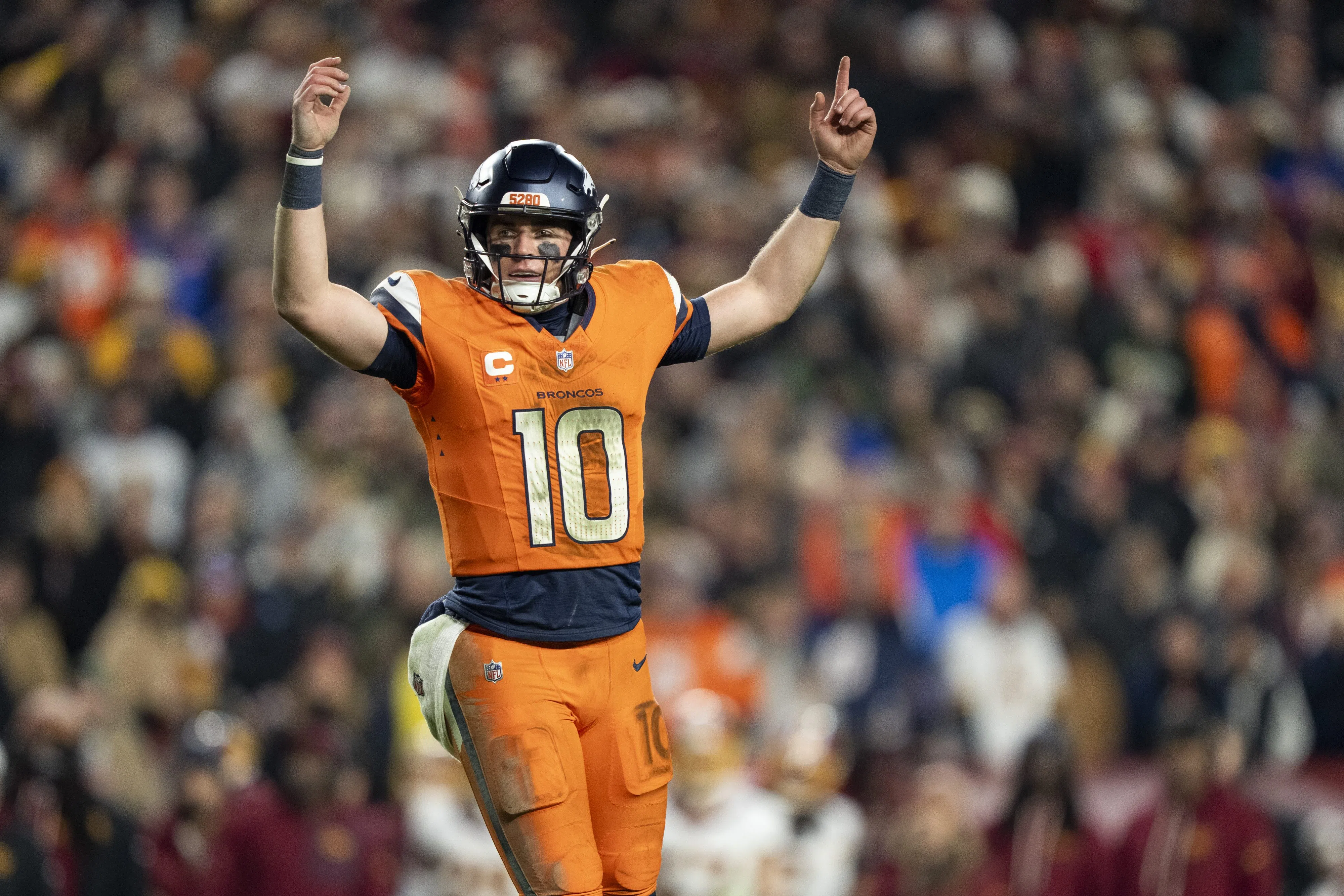 LANDOVER, MARYLAND - NOVEMBER 30: Bo Nix #10 of the Denver Broncos celebrates after a touchdown during an NFL football game against the Washington Commanders at Northwest Stadium on November 30, 2025 in Landover, Maryland. (Photo by Michael Owens/Getty Images)