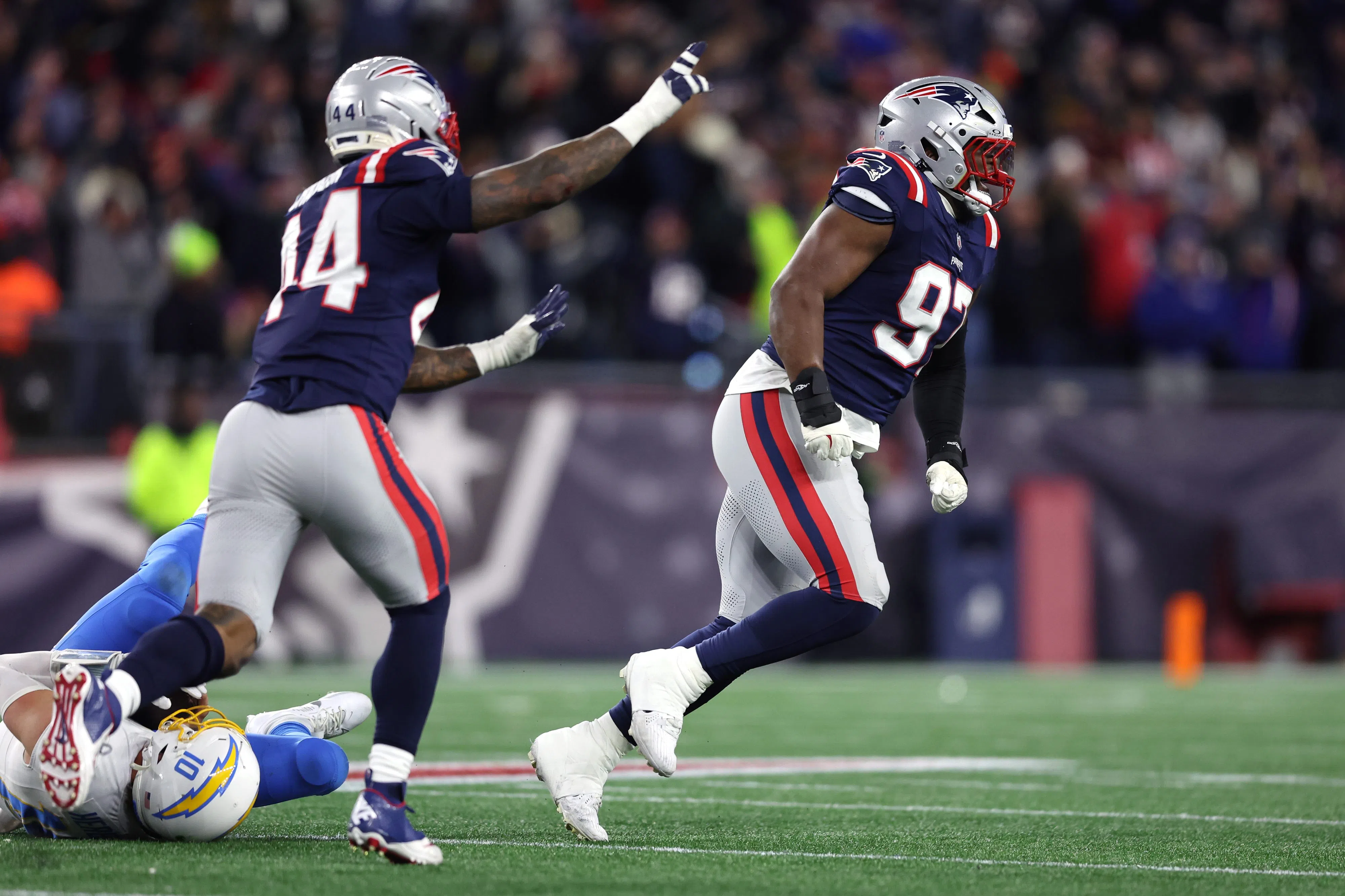 FOXBOROUGH, MASSACHUSETTS - JANUARY 11: Milton Williams #97 of the New England Patriots celebrates after a sack of Justin Herbert #10 of the Los Angeles Chargers during the fourth quarter of the AFC Wild Card Playoff game at Gillette Stadium on January 11, 2026 in Foxborough, Massachusetts. (Photo by Adam Glanzman/Getty Images)