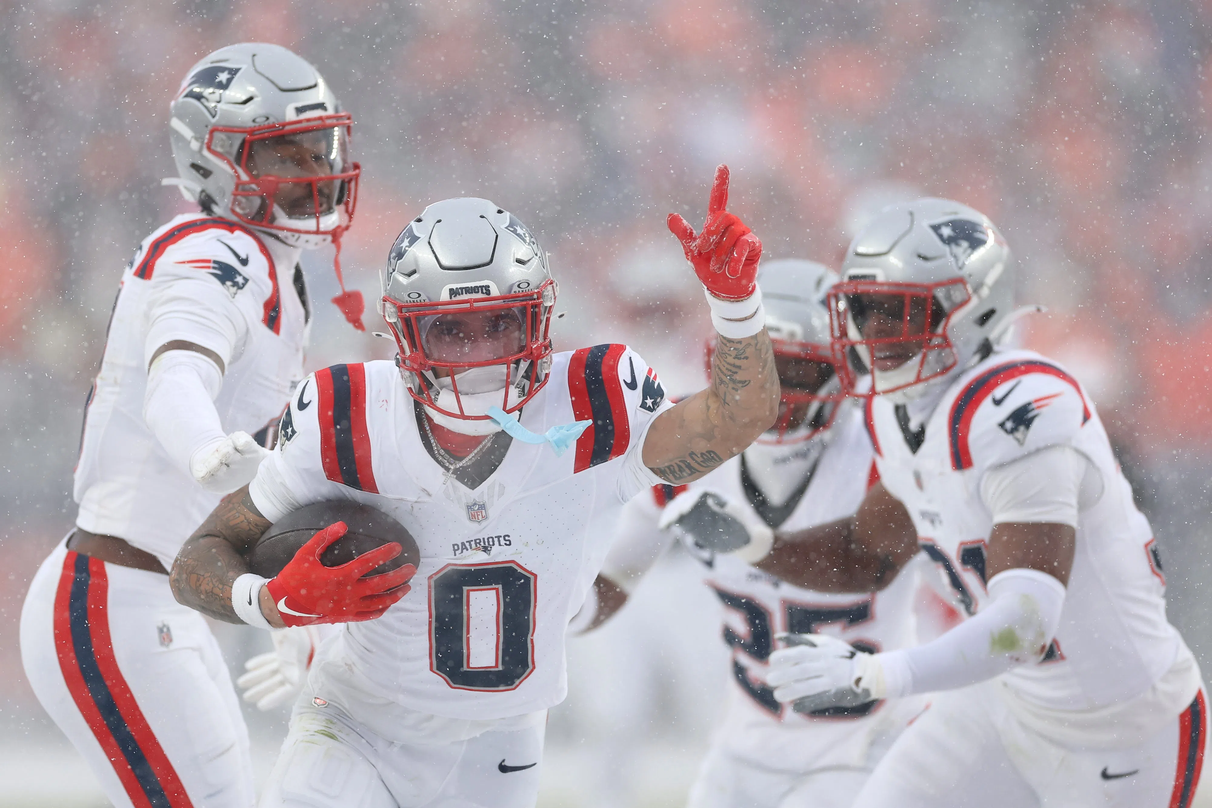 DENVER, COLORADO - JANUARY 25: Christian Gonzalez #0 of the New England Patriots celebrates with teammates after intercepting a pass from Jarrett Stidham #8 of the Denver Broncos (not pictured) intended for Marvin Mims Jr. #19 (not pictured) during the fourth quarter in the AFC Championship Playoff game at Empower Field At Mile High on January 25, 2026 in Denver, Colorado. The New England Patriots defeat the Denver Broncos 10-7. (Photo by Matthew Stockman/Getty Images)
