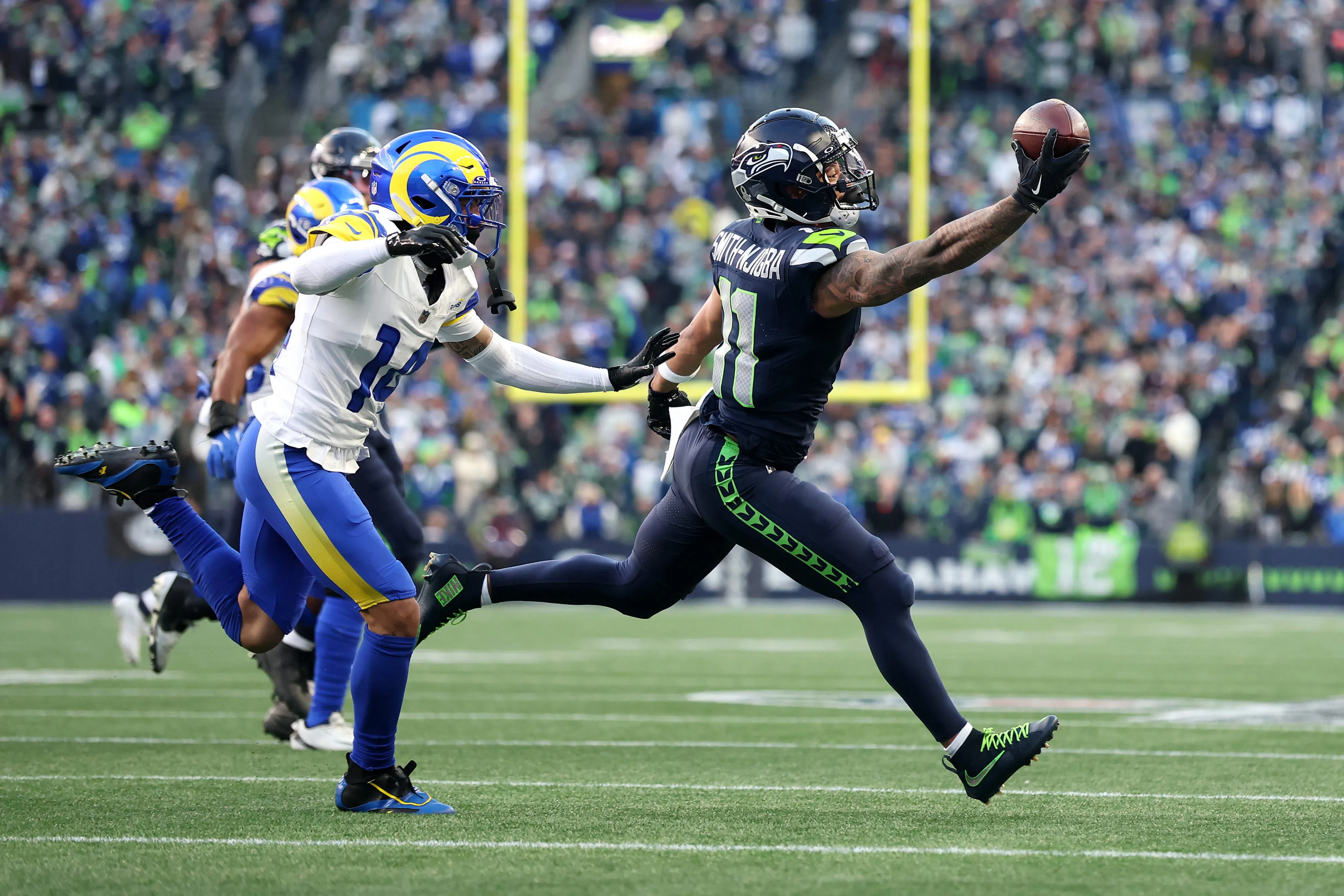 SEATTLE, WASHINGTON - JANUARY 25: Jaxon Smith-Njigba #11 of the Seattle Seahawks pulls in a one handed catch in front of Cobie Durant #14 of the Los Angeles Rams during the first quarter in the NFC Championship game at Lumen Field on January 25, 2026 in Seattle, Washington. (Photo by Steph Chambers/Getty Images)