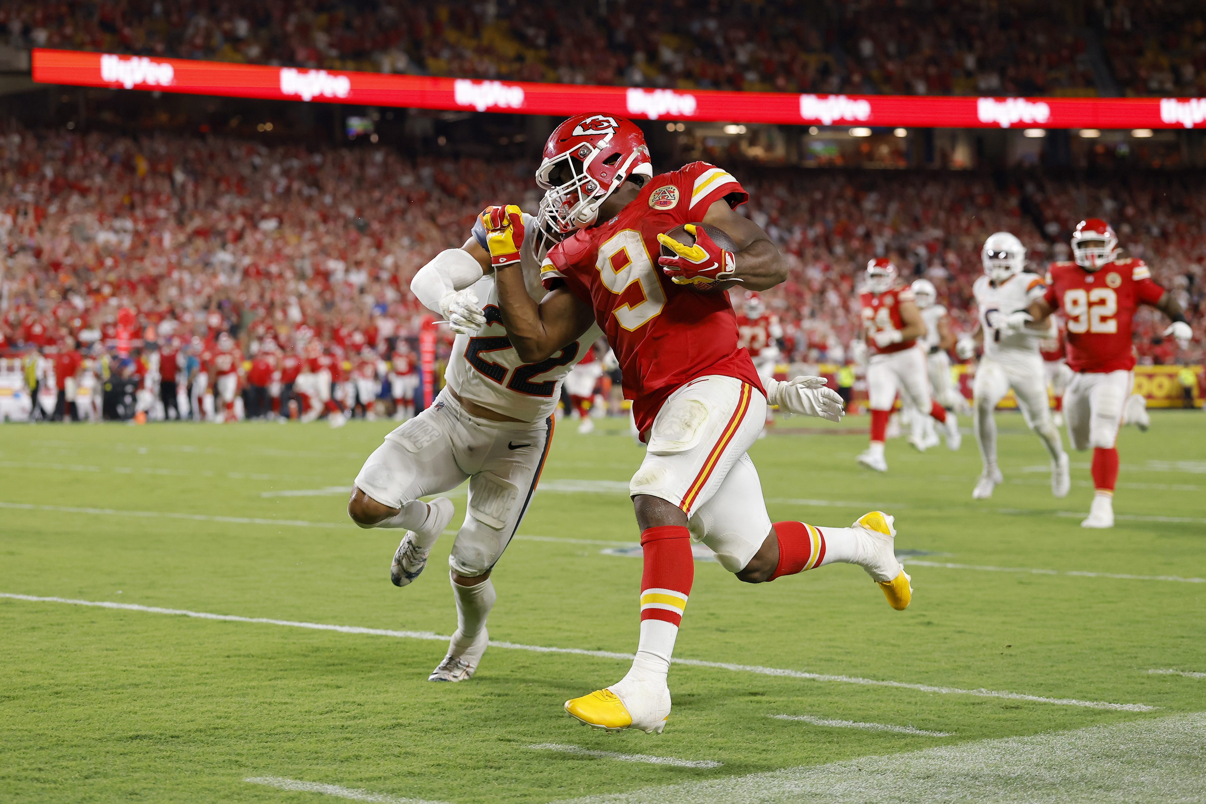 KANSAS CITY, MISSOURI - SEPTEMBER 14: Kenneth Walker III #9 of the Kansas City Chiefs breaks a tackle by Brandon Jones #22 of the Denver Broncos to score a 60 yard touchdown during the third quarter in the game at Arrowhead Stadium on September 14, 2026 in Kansas City, Missouri. (Photo by David Eulitt/Getty Images)