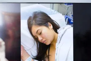 A monitor displays images of Andrea Buera with injuries allegedly caused by Trey Songz