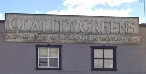 The history behind the 'Quality Greens Place' sign in Downtown Milton