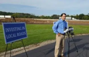 Walker warns of project delays if transportation split from budget