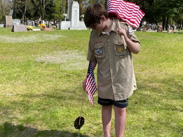 Volunteers Put Old Glory In Place For Monday