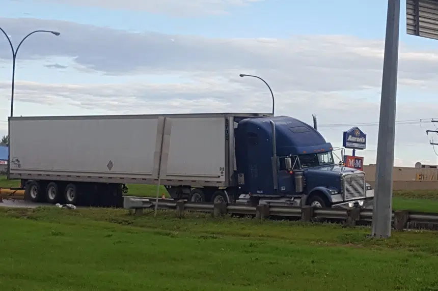 Semi-trailer stuck after hitting concrete barrier in Saskatoon