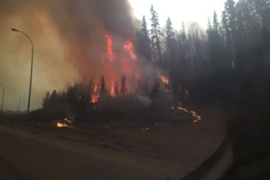 Fire burns in Fort McMurray as people flee their homes