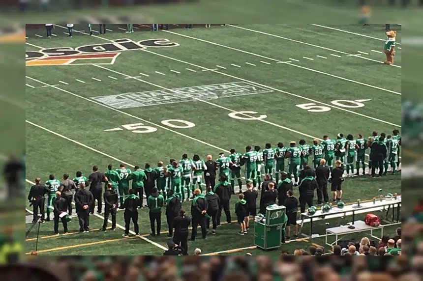 'A sign of unity:' Riders link arms during national anthem