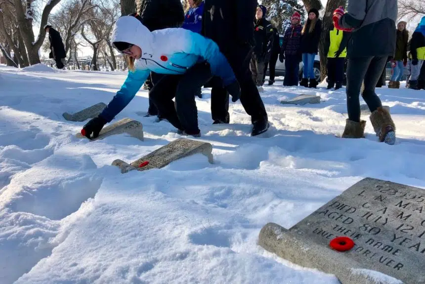 Regina students lay poppies on graves of war veterans
