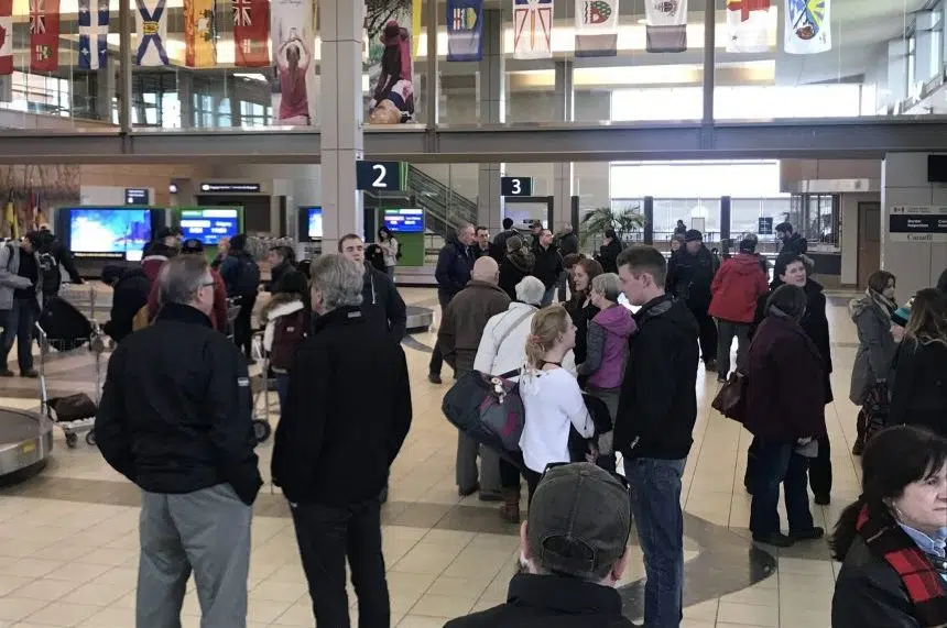 Smiles, hugs and signs greet Christmas travellers at airport