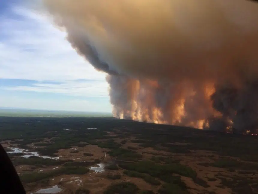 Winds helping in battle against fire threatening northern Alberta town
