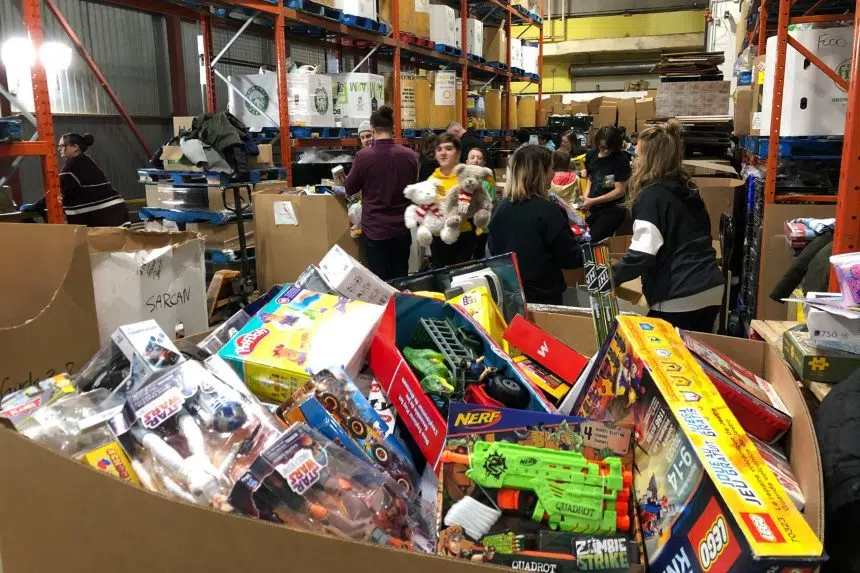 Students and volunteers sort toys ahead of Santas Anonymous wrap day