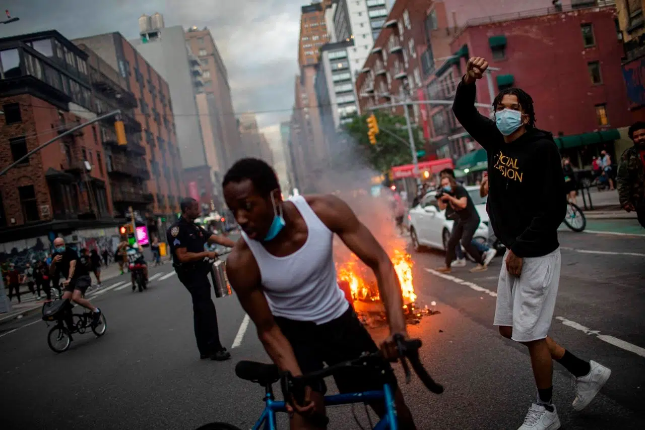 Police cars burn, windows shatter as protests roil New York