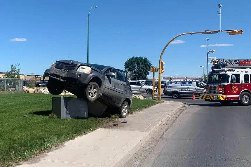 Vehicle hung up on power box ties up traffic