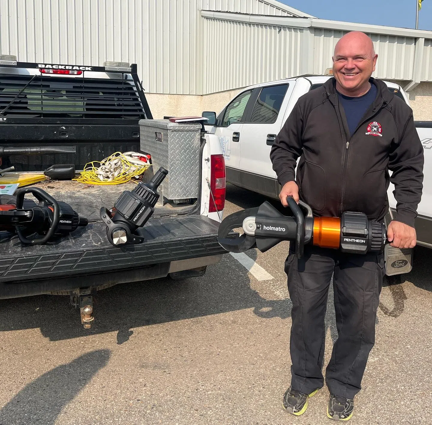 Randy Schulz poses with a piece of firefighting equipment