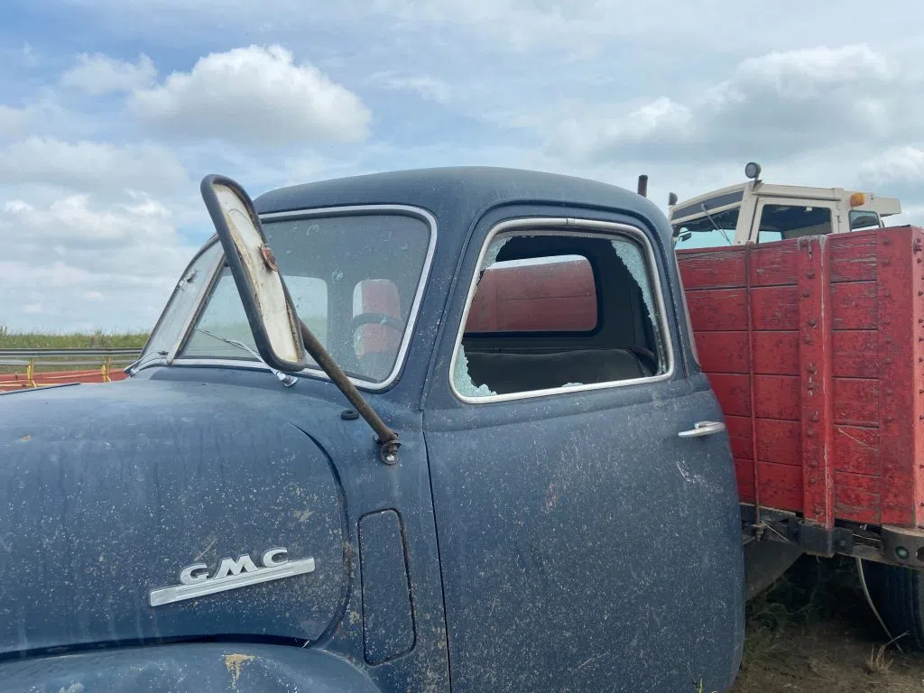 Eberle's father told 980 CJME this truck had no damage prior to the tornado. Now, its windows are smashed and was rammed into a tractor. (Nicole Garn/980 CJME)