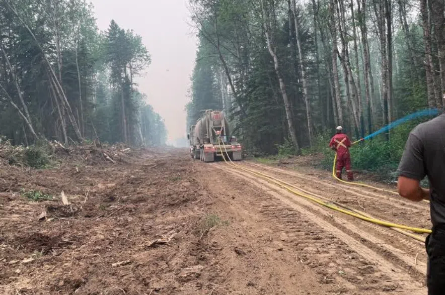 Nipawin fire crews spray retardant.