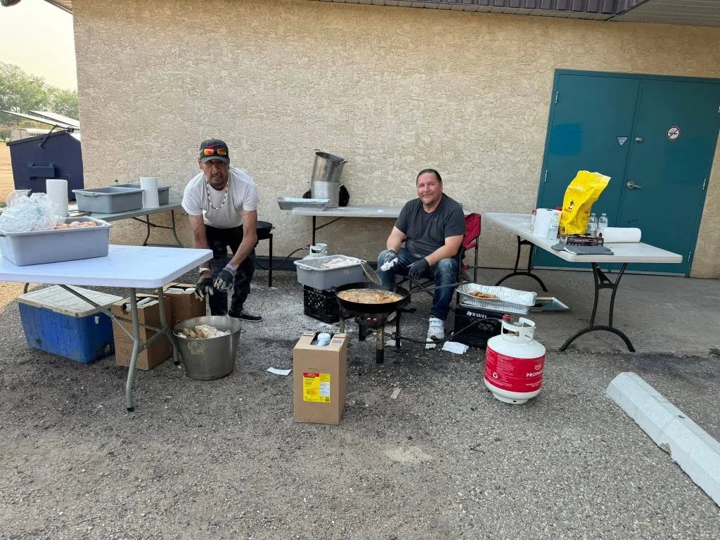 Volunteers Walter Michel (left) and George Bird frying the fish for evacuees. (Tommy Bird/submitted)
