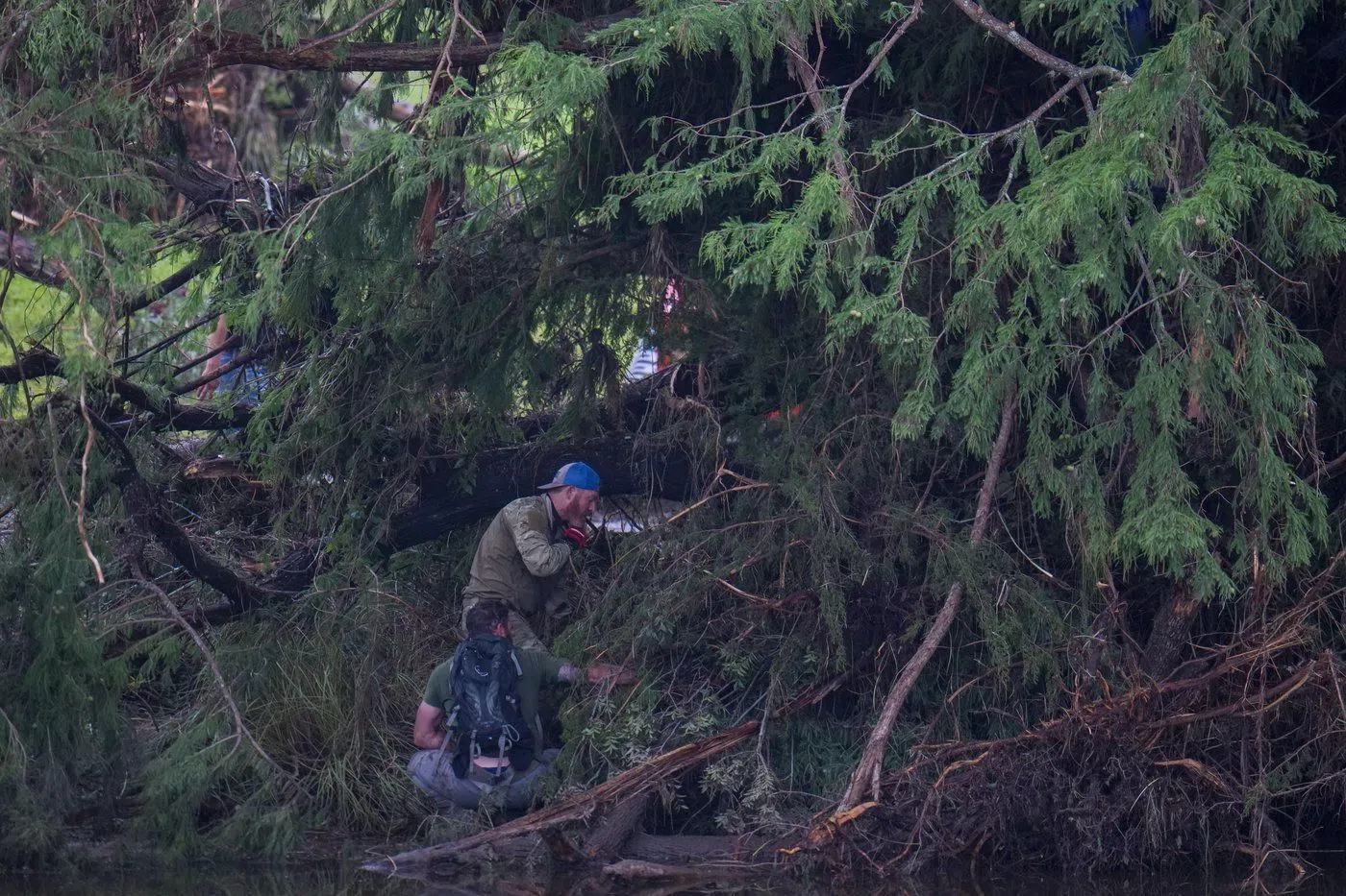 Searchers on banks of the Guadalupe River.