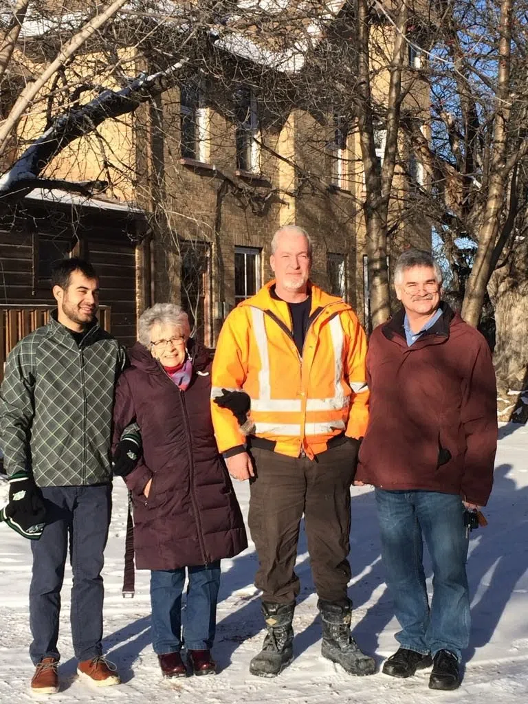 Reza, Louise Lee, Michael Lee, and Rick Lee standing outside McDonald House in winter