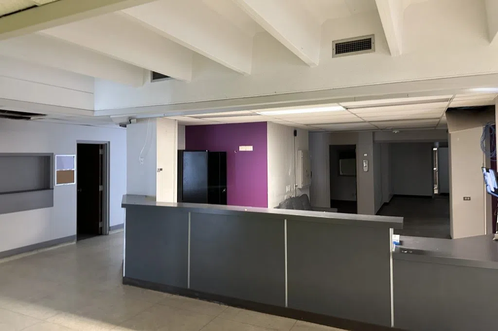 An empty front desk without furniture or items during renovations