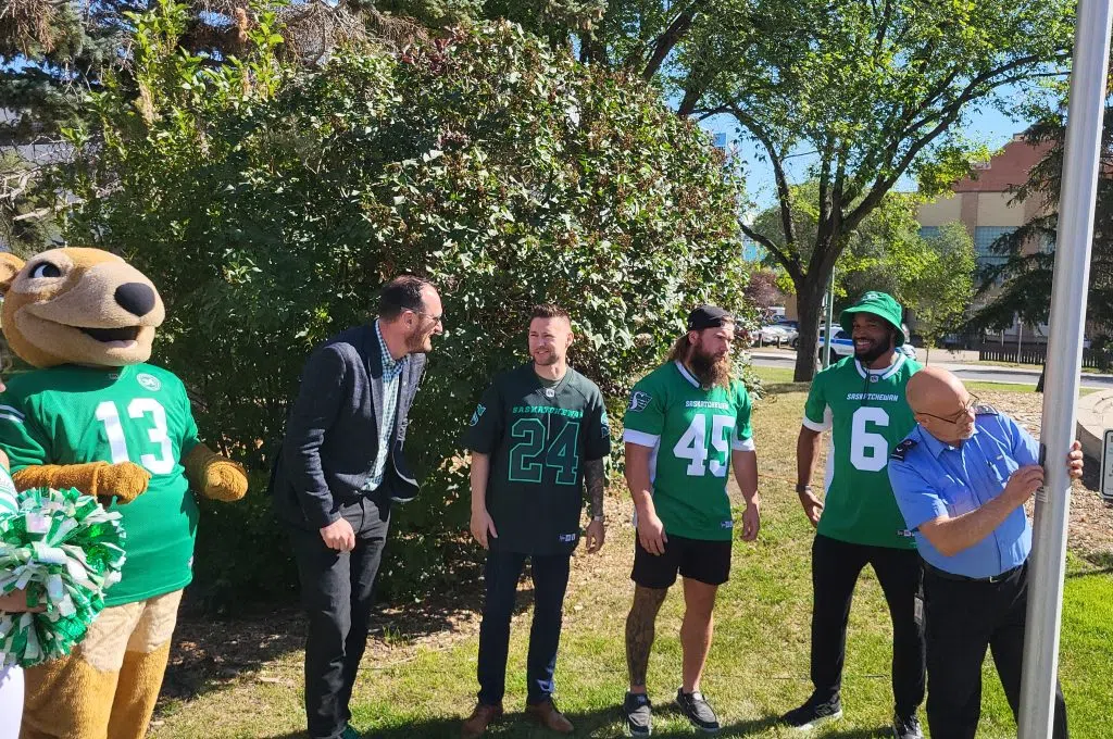 DR Regina mayor with Rider players and executive
