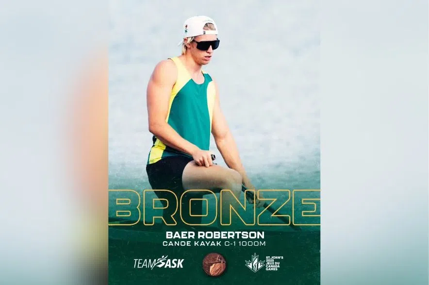 Canoe kayaker Baer Robertson wearing sunglasses and Team Saskatchewan gear after winning a bronze medal.