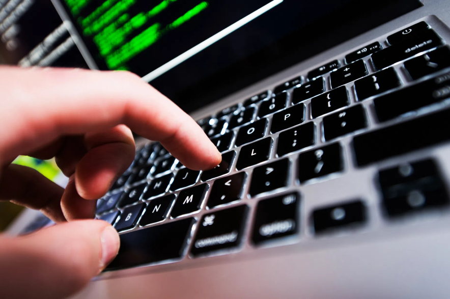 A person types on a laptop computer.