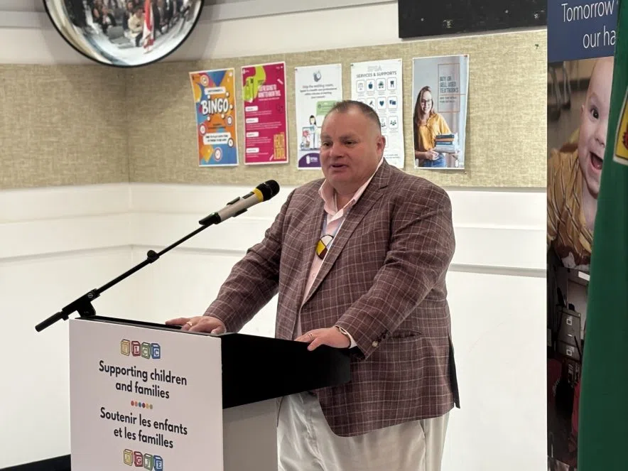 Michael McCormick speaks at podium during childcare funding announcement in Regina.