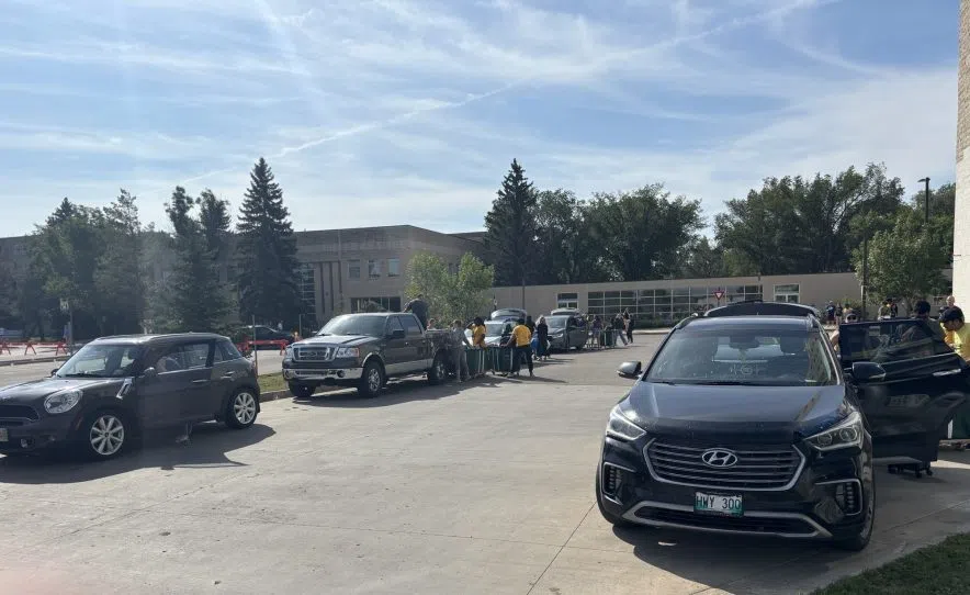 Families unload vehicles outside residence buildings at the University of Regina during move-in day, where more than 500 first-year students arrived on campus.
