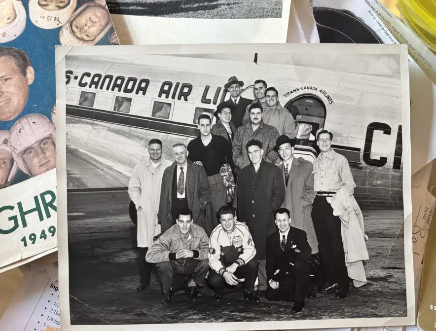 Vintage Saskatchewan Roughriders team photo in front of Trans-Canada Airlines plane with Bob Pelling.