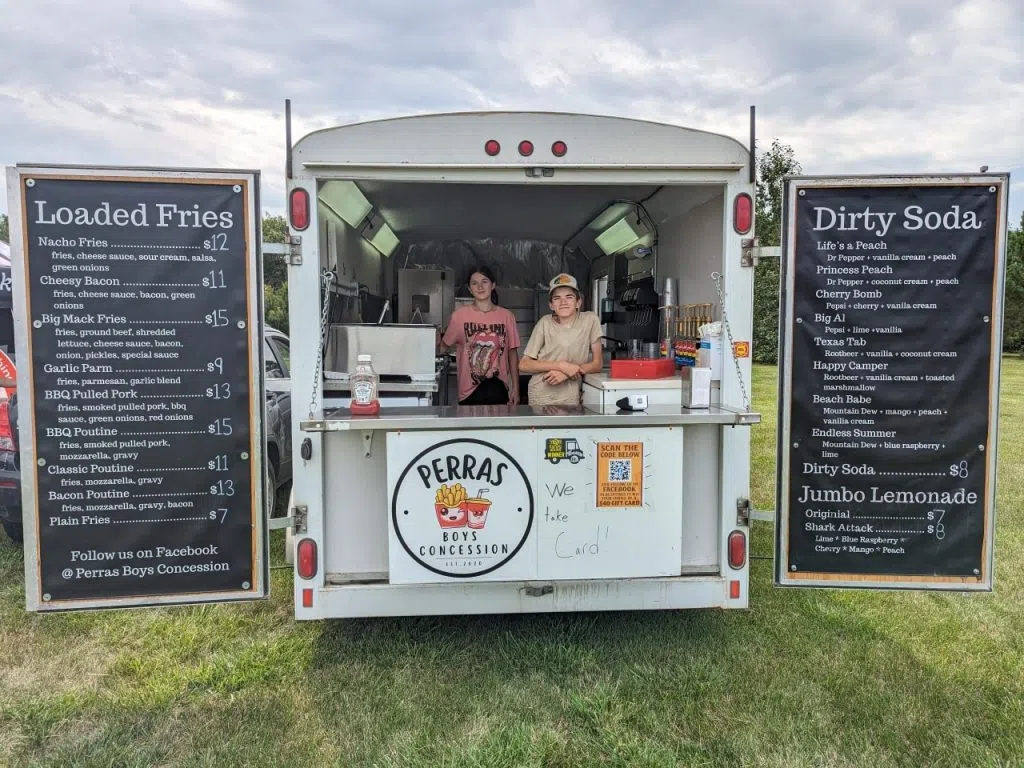 Perras Boys Concession serves fries and dirty sodas with its two food trucks. Jonah (right) stands with his sister in the truck. (Jonah Perras/ Facebook)