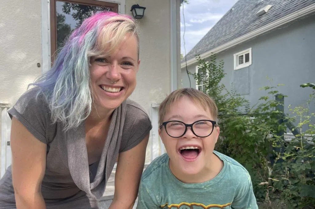 Deidra and Xavier stand outside their home in Weyburn. (Gillian Massie/ 980 CJME)