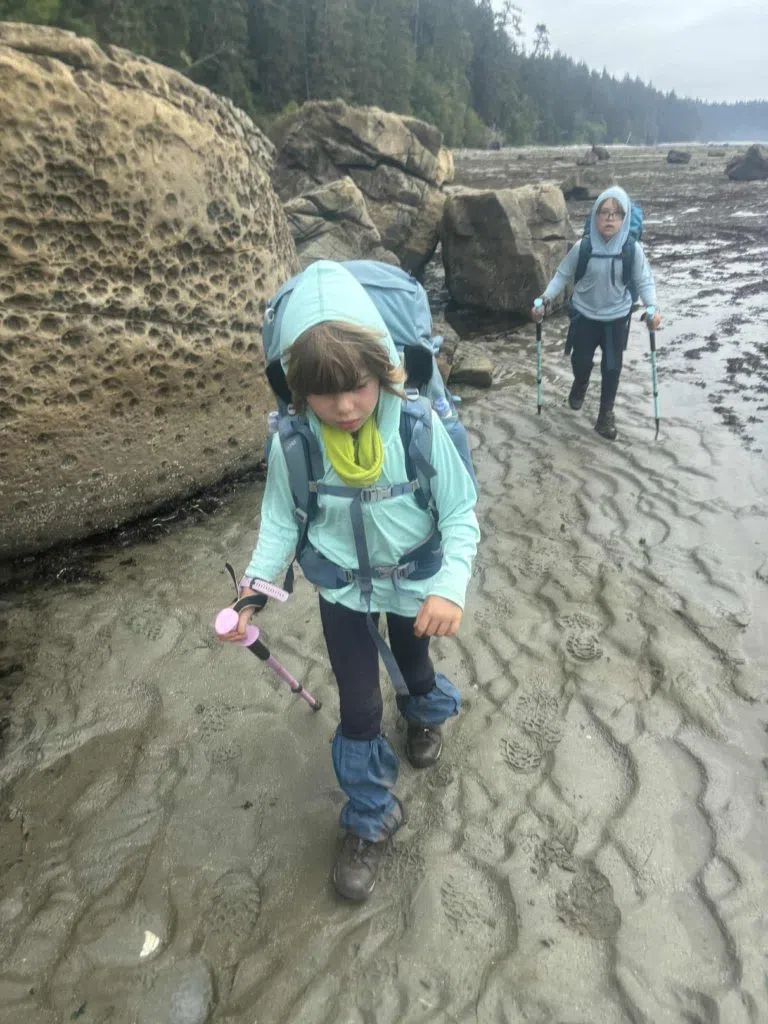 Johanna and Xavier hike through muddy beaches on the West Coast Trail. (Deidra Cameron/Submitted) 