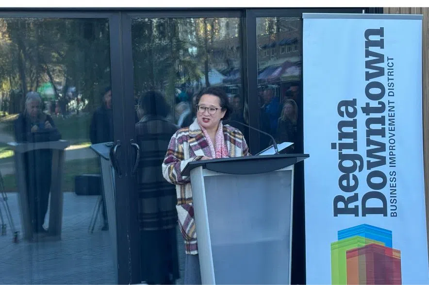 Judith Veresuk, executive director of the Regina Downtown Business Improvement District, speaks at a podium during the announcement of federal funding for The Skuare project in downtown Regina.