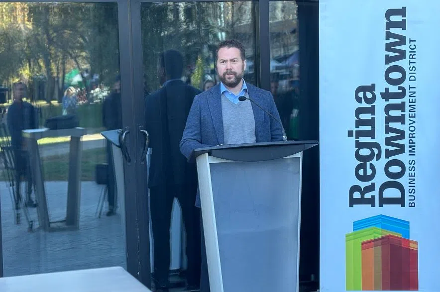Kenric Exner of Harvard Developments speaks at a podium during The Skuare federal funding announcement in downtown Regina.